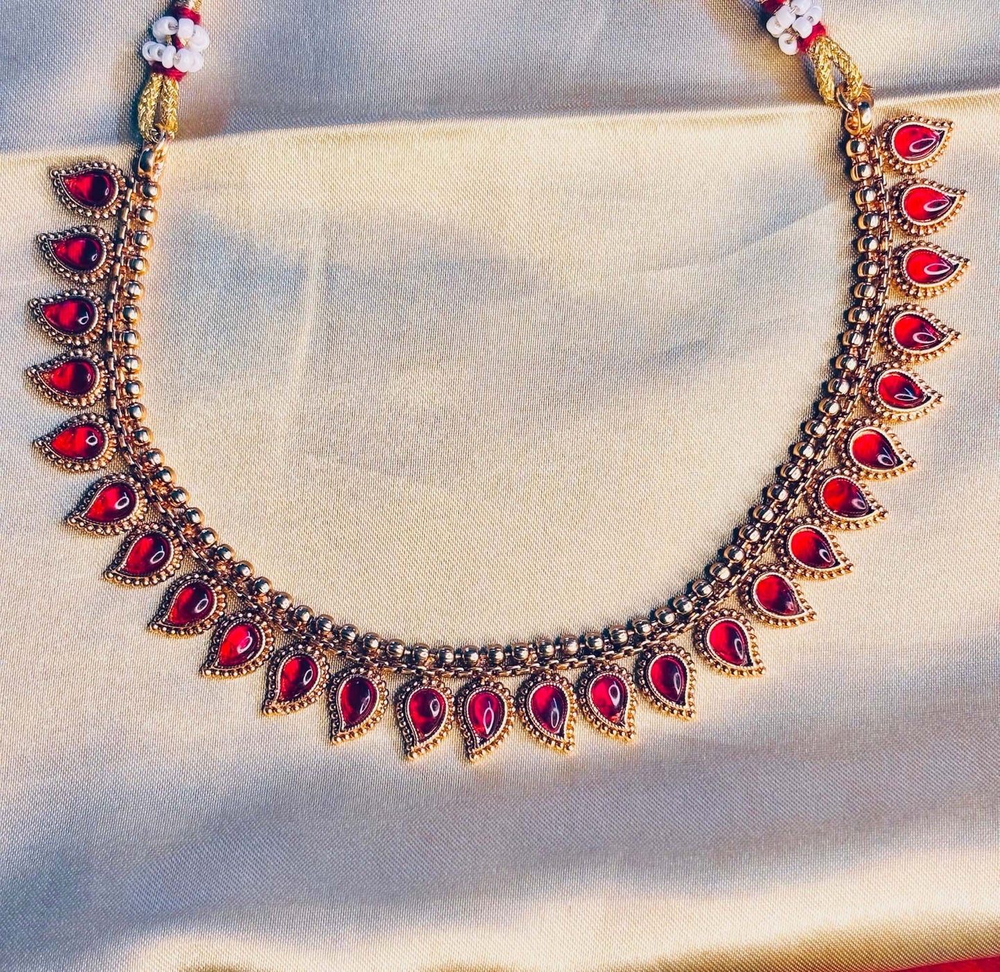 Bridal kundan choker set with red teardrop stones and gold base