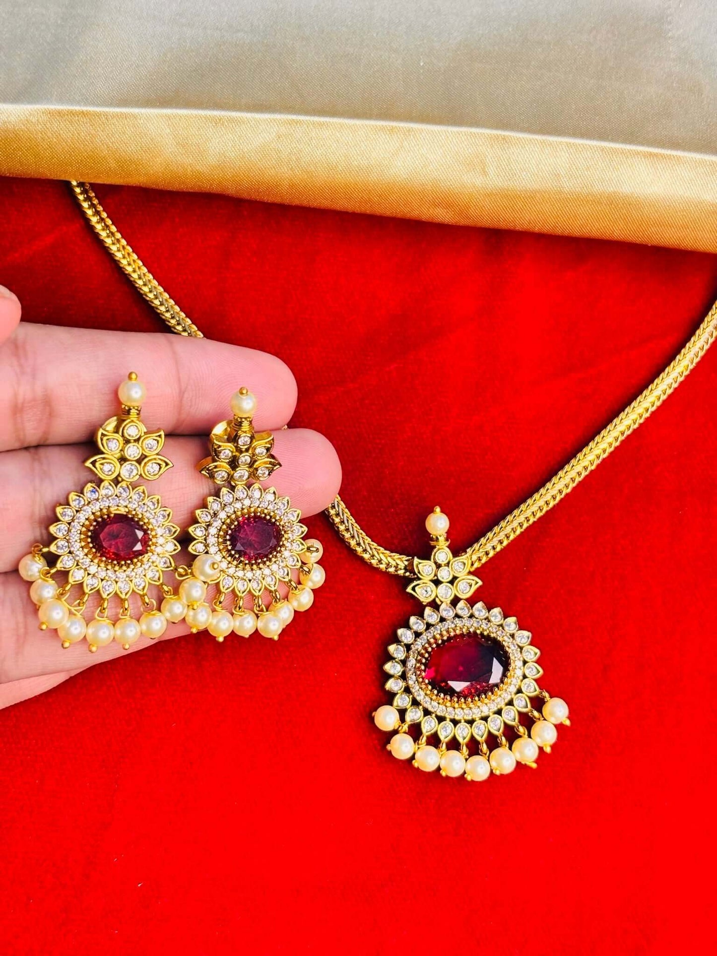 Grand ruby pendant necklace set with pearl drops and CZ stone detailing