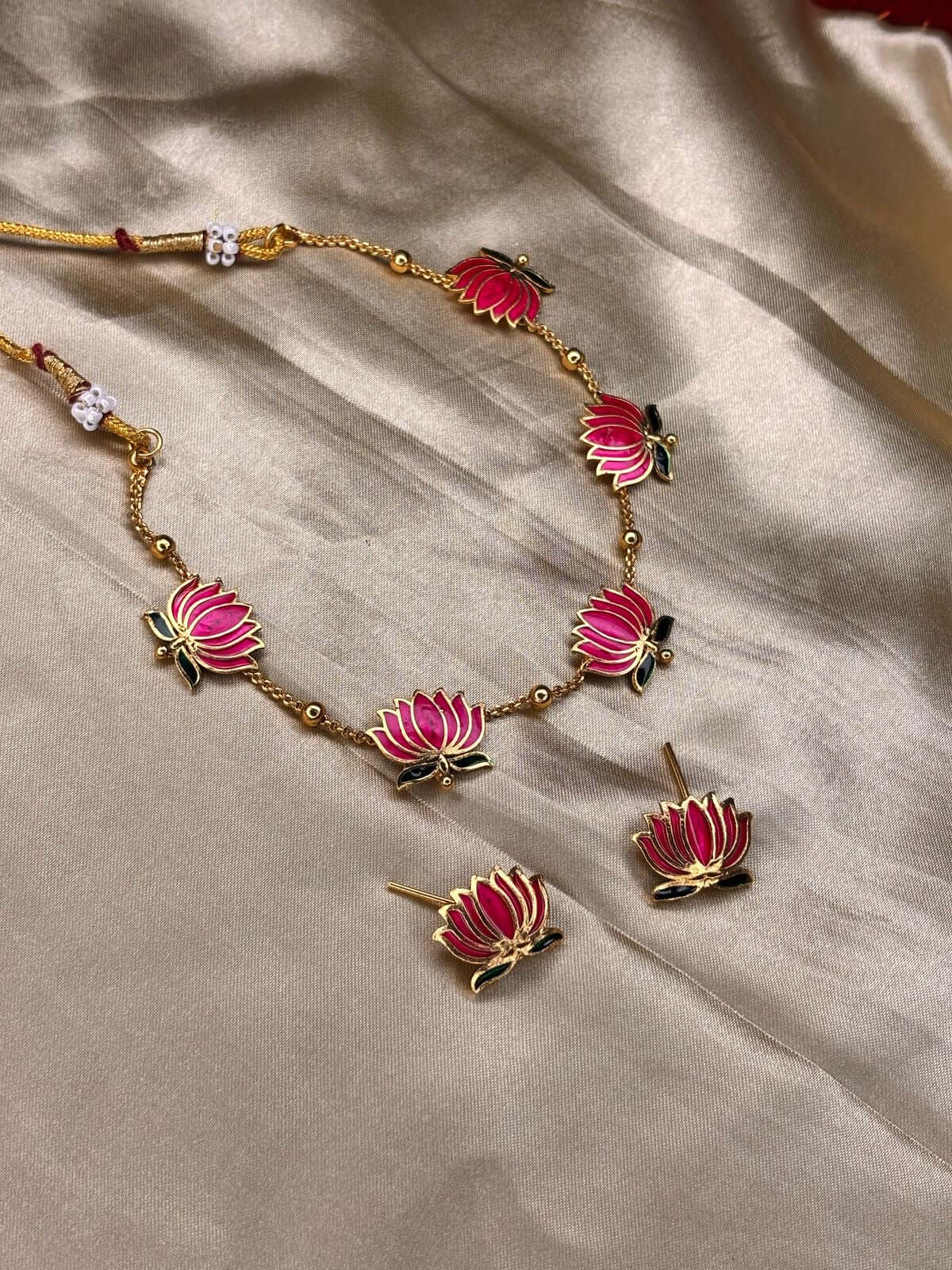 Elegant enamel jewelry set with pink lotus design and gold-plated detailing