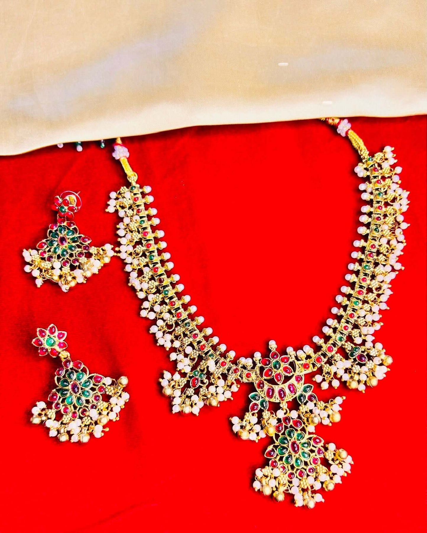 Royal temple necklace set adorned with kundan stones and pearl embellishments