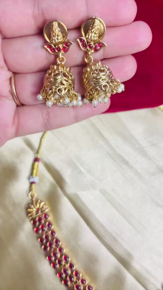 Antique gold choker set with Lakshmi idol centerpiece and matching Jhumka earrings